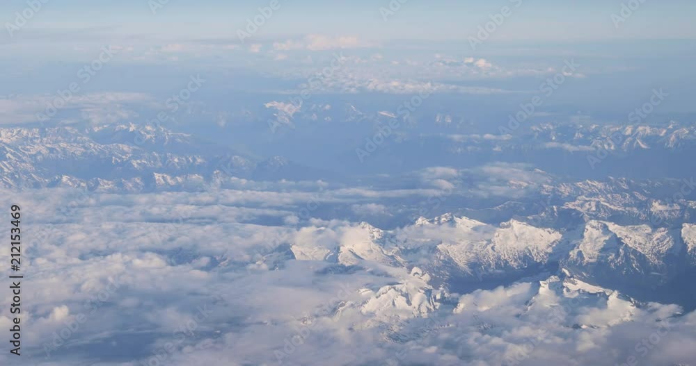 Aerial View From Airplane Window On Snowy Top Of Tatra Mountains In Summer Day. High Attitude Aerial View From Airplane Window On Snowy Top Of Tatra Mountains In Summer Day. High Attitude