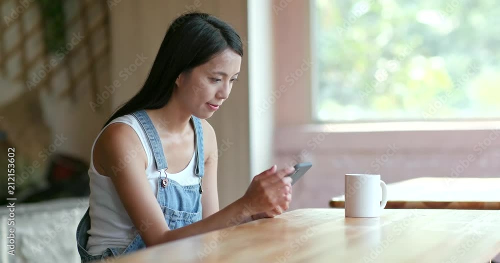 Woman use of mobile phone in morning coffee shop Woman use of mobile phone in morning coffee shop