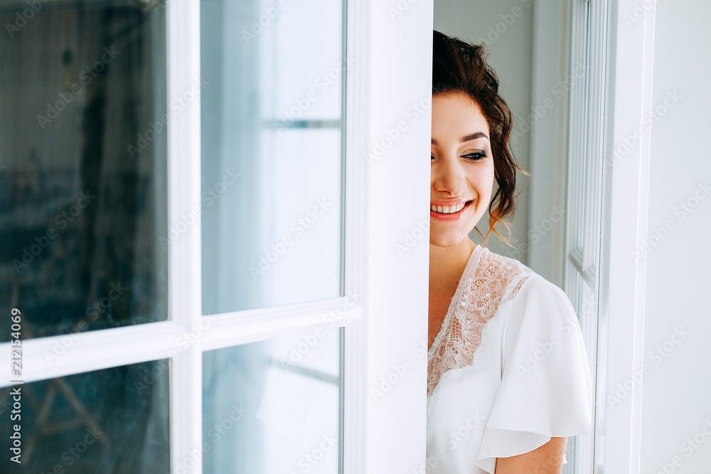 Tender elegant young bride with hairdo, hairpin and bridal makeup Tender elegant young bride with hairdo, hairpin and bridal makeup