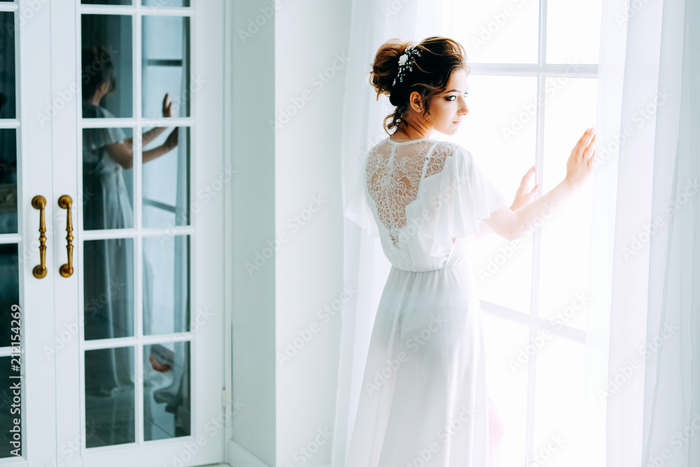 Tender elegant young bride with hairdo, hairpin and bridal makeup Tender elegant young bride with hairdo, hairpin and bridal makeup