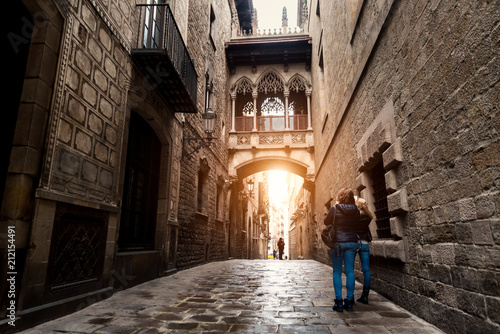 Woman tourist sightseeing in Barcelona Barri Gothic Quarter and Bridge of Sighs in Barcelona, Catalonia, Spain.. photo