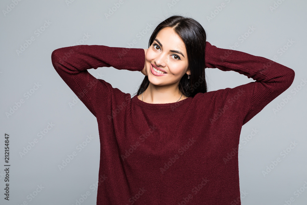 Young smile woman pretty brunette isolated on grey background Young smile woman pretty brunette isolated on grey background