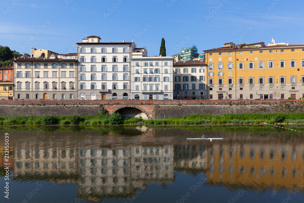 Colorful houses  are mirrored in riiver. Florence, Italy