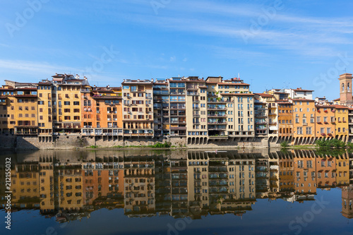 Colorful houses are mirrored in riiver. Florence, Italy