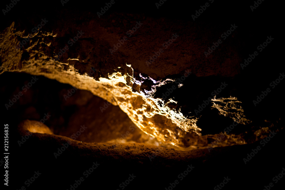 Fototapeta premium Stalactites and stalagmites inside natural limestone cave. Natural formations.