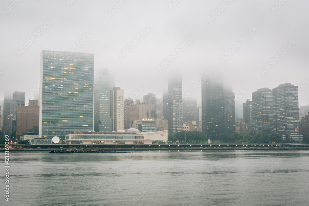 Foggy view of the Manhattan skyline from Gantry Plaza State Park, in Long Island City, Queens, New York City.