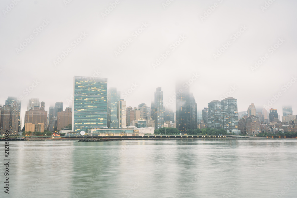 Foggy view of the Manhattan skyline from Gantry Plaza State Park, in Long Island City, Queens, New York City.