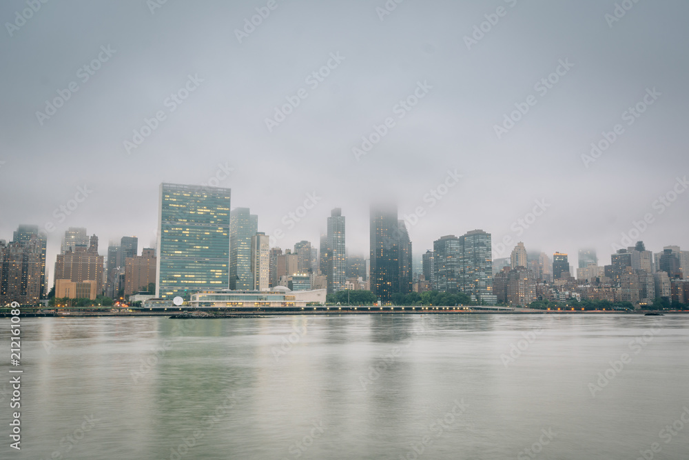 Foggy view of the Manhattan skyline from Gantry Plaza State Park, in Long Island City, Queens, New York City.