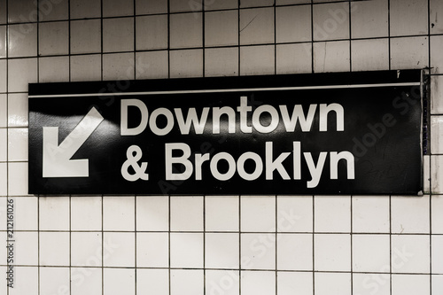 Downtown & Brooklyn sign in a subway station in Manhattan, New York City. photo