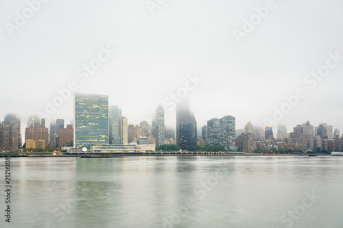Foggy view of the Manhattan skyline from Gantry Plaza State Park, in Long Island City, Queens, New York City. © jonbilous