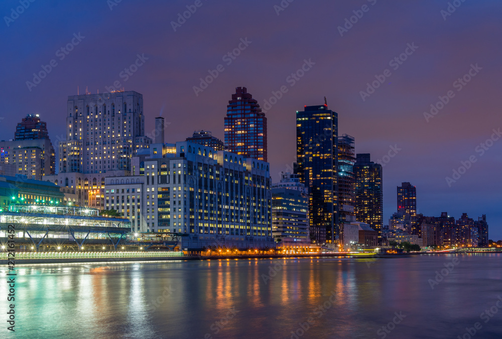 Manhattan and the East River at night, seen from Roosevelt Island, in New York City.