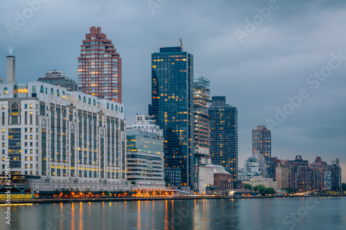 Manhattan and the East River at night, seen from Roosevelt Island, in New York City.