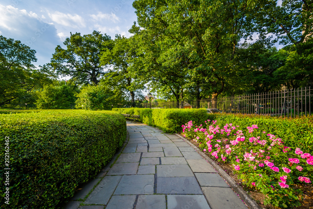 Walkway and flowers at the Conservatory Garden, in Central Park, Manhattan, New York City.