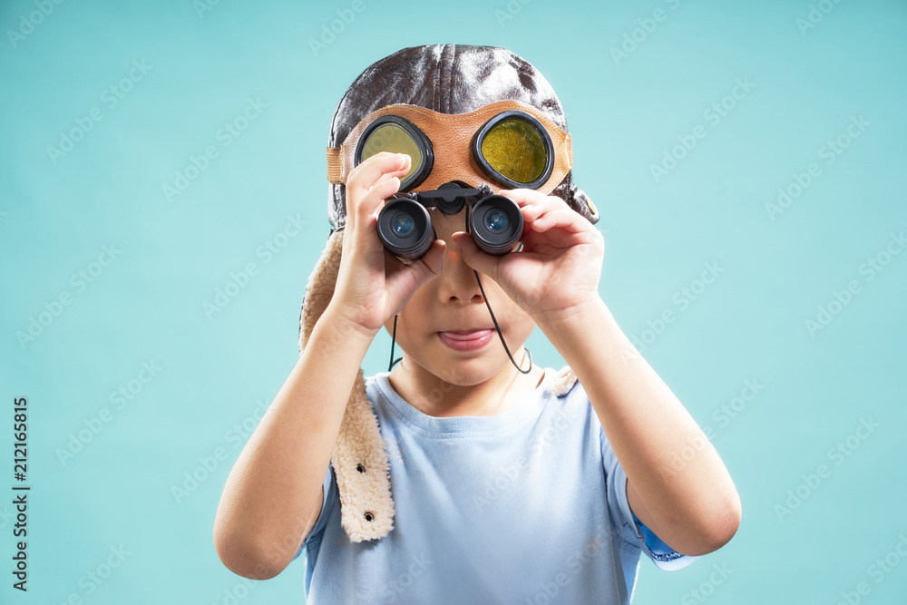Little young cute asian boy using telescope looking forward . Little young cute asian boy using telescope looking forward .