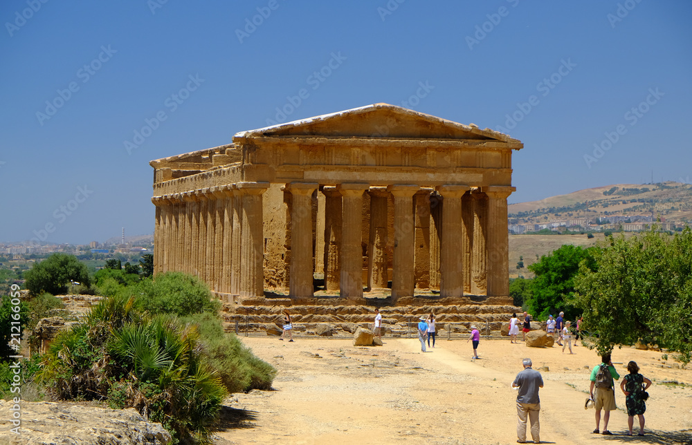 Fototapeta premium Tourists at a temple in the Valley of Temples, Agrigento, Sicily