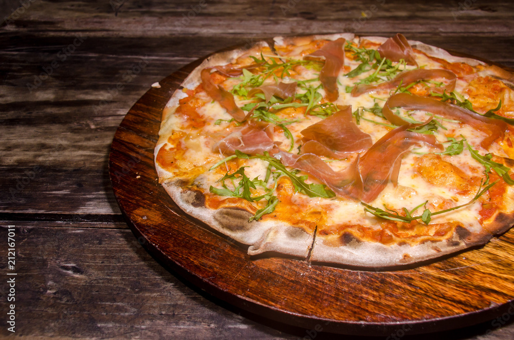 handmade prosciutto pizza prepared on a clay furnace pizza