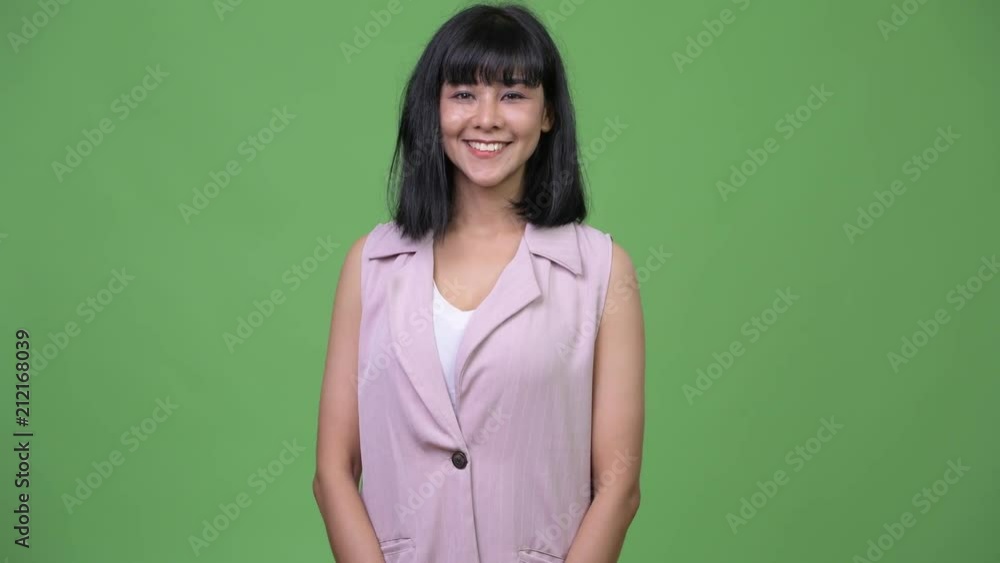 Young happy beautiful Asian businesswoman smiling Young happy beautiful Asian businesswoman smiling