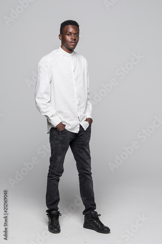 Beautiful full body happy black afro american man isolated on gray background © dianagrytsku
