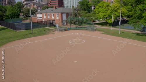 Wallpaper Mural drone flying over baseball diamond in urban park and revealing city buildings in Clayton. Torontodigital.ca