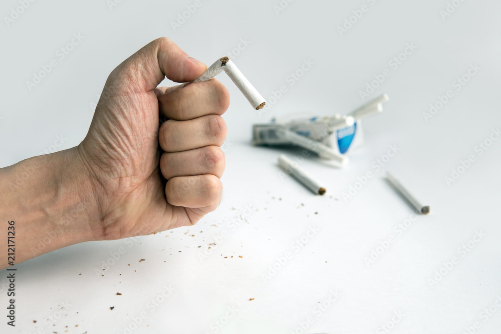 Fotografie Broken cigarette in man hands,Stop smoking