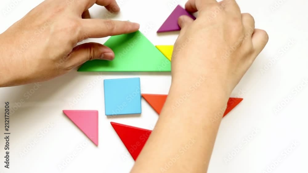 Man complete tangram puzzle in heart shape on white background (Concept for love) Man complete tangram puzzle in heart shape on white background (Concept for love)