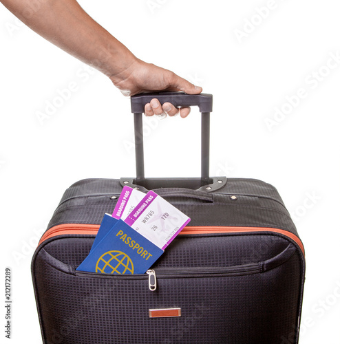 Billede på lærred Man holds suitcase in his hand and two tickets for airplane peep out of pocket