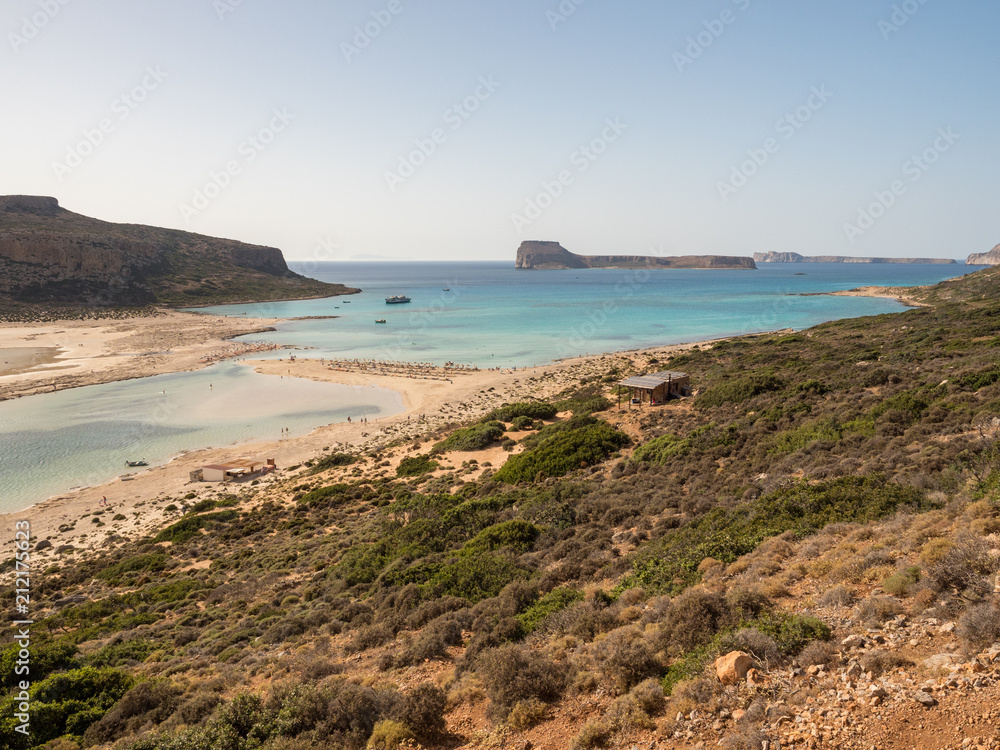 Balos lagoon and beach on Crete island. Tourists relax and bath in crystal clear water. Greece, june 2018