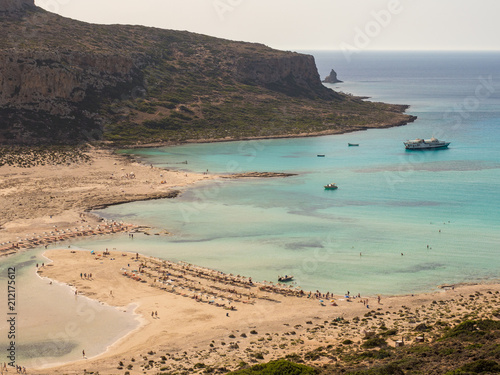 Balos lagoon and beach on Crete island. Tourists relax and bath in crystal clear water. Greece, june 2018 photo