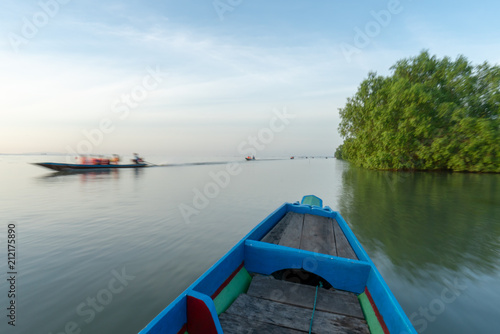Long tail boat head view fast sailing moving fast © Thanunchakorn