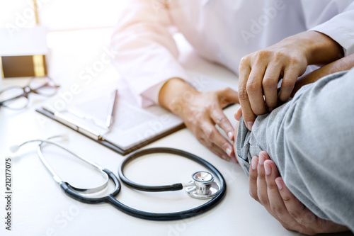 Doctor examining patients elbow at the medical office