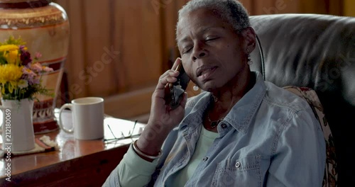 Frustrated, mad, senior black woman talking on her mobile phone