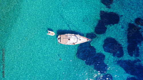 Aerial birds eye view photo taken by drone of famous tropical rocky beach of Agios Georgios with yachts docked, Symi island, Dodecanese, Greece © aerial-drone