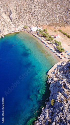 Aerial bird's eye view photo taken by drone of famous tropical rocky beach of Agios Nikolaos with clear turquoise waters, Symi island, Dodecanese, Greece photo