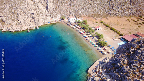 Aerial bird's eye view photo taken by drone of famous tropical rocky beach of Agios Nikolaos with clear turquoise waters, Symi island, Dodecanese, Greece photo