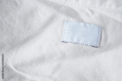 White blank laundry care clothes label on cotton shirt © Kwangmoozaa