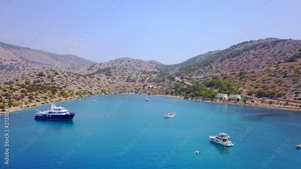 Aerial bird's eye view photo taken by drone of bay and iconic Monastery of Panormitis, Symi island, Dodecanese, Greece