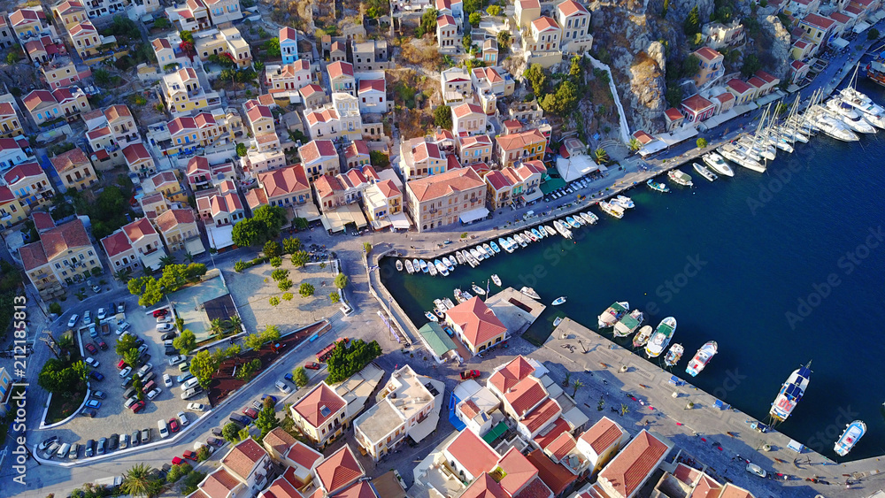 Aerial birds eye view photo taken by drone of Yalos, iconic port of Symi island at sunset with beautiful clouds, Dodecanese, Greece