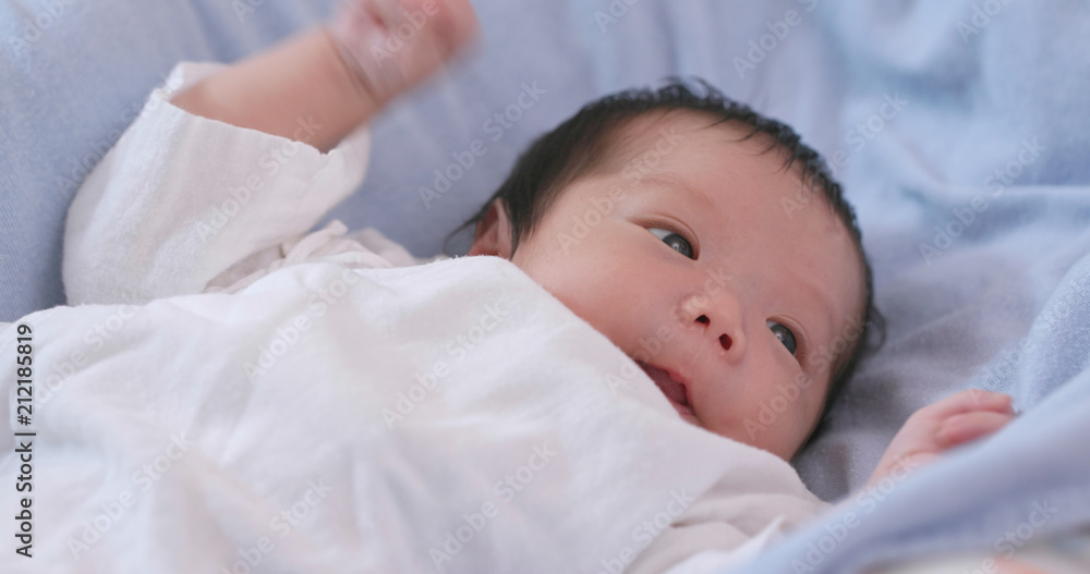 Asian new born baby lying on bed Asian new born baby lying on bed