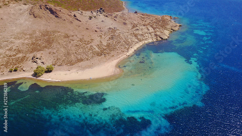 Aerial bird's eye view photo taken by drone of famous rocky beach of Livadi Geranou with turquoise clear waters, Patmos island, Greece