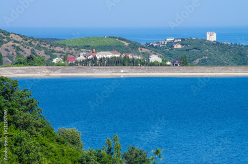 Fototapeta Naklejka Na Ścianę i Meble -  View of the city of Alushta from the shore of the reservoir, Crimea