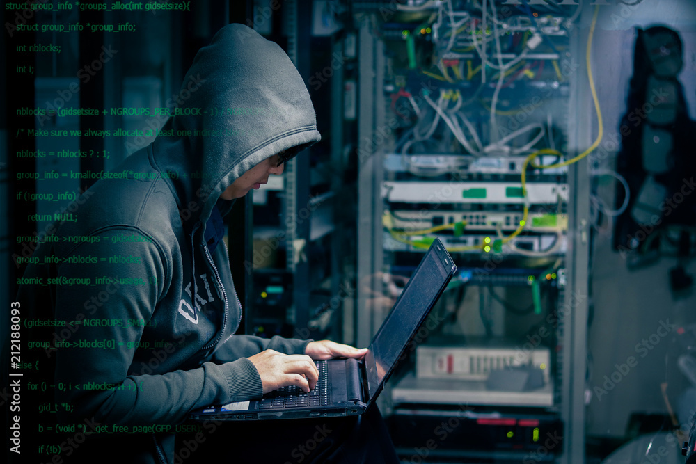 Internet crime concept. Hacker working on a code on dark digital background with digital interface around. Internet crime concept. Hacker working on a code on dark digital background with digital interface around.