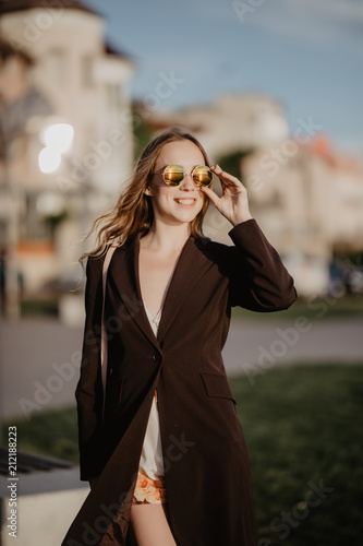 Portrait of sensual beautiful young woman having fun smiling pretty outdoors on sunset