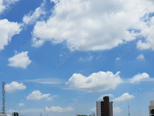 Beautiful nature of blue sky and clouds with buildings and antennas, sky background, cloudscape concept. Space for text in template, Empty, Looking up