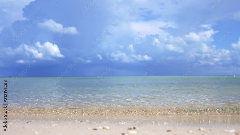 Paradise landscape of amazing tropical beach. Ocean waves and cloudy sky background. White sand and crystal-blue sea. slwo motion. 3840x2160 Paradise landscape of amazing tropical beach. Ocean waves and cloudy sky background. White sand and crystal-blue sea. slwo motion. 3840x2160
