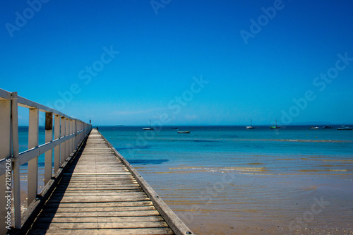 wooden pier on a beach seascape © Cat Bell