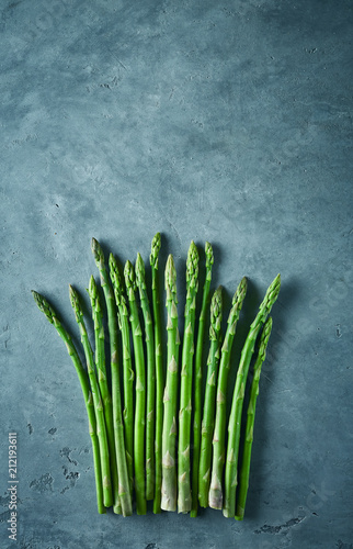 bunch of asparagus on dark concrete background