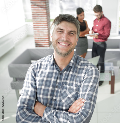Smiling mature businessman in plaid shirt foreground
