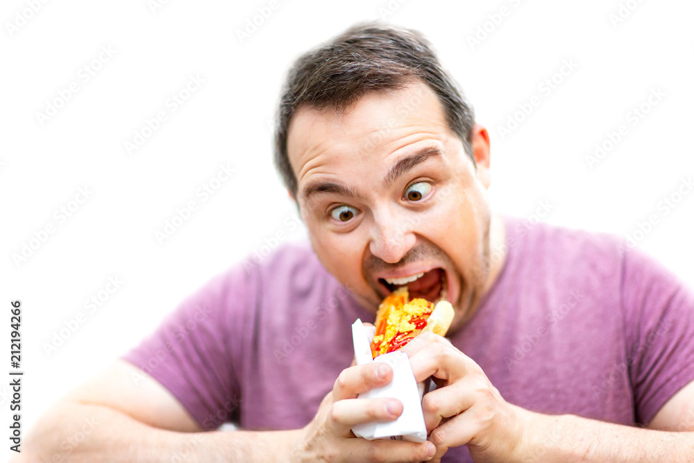 Hungry man with crazy eyes is eating hot dog isolated at white background. Hungry man with crazy eyes is eating hot dog isolated at white background.