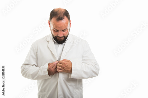 Portrait of male doctor buttoning his coat gesture © Catalin Pop