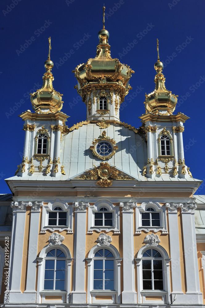 The building of the church under the blue sky with golden domes